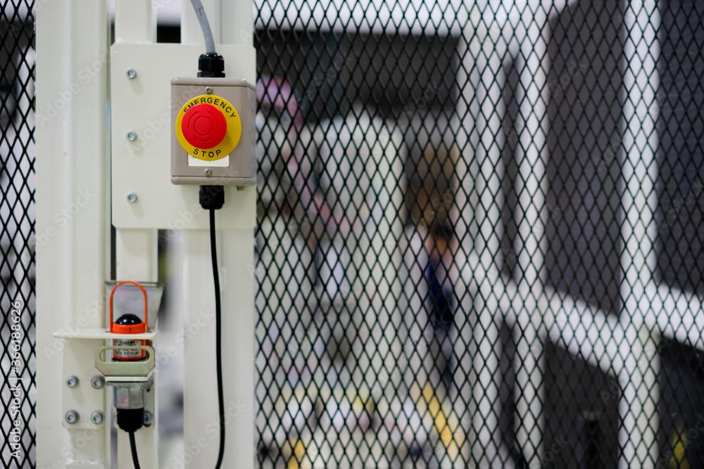 Emergency-stop switch on the safety guarding of a machine